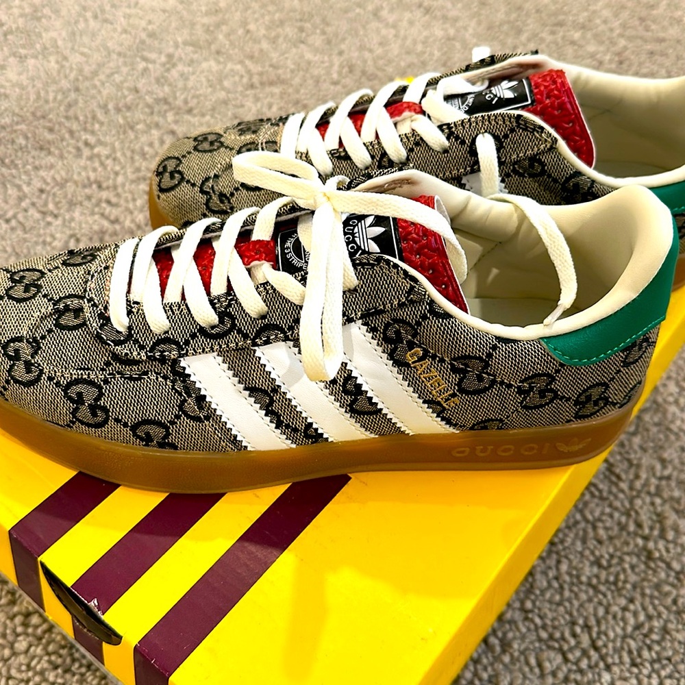 Designer inspired three stripes. New. Women’s size 5 but runs big. $55